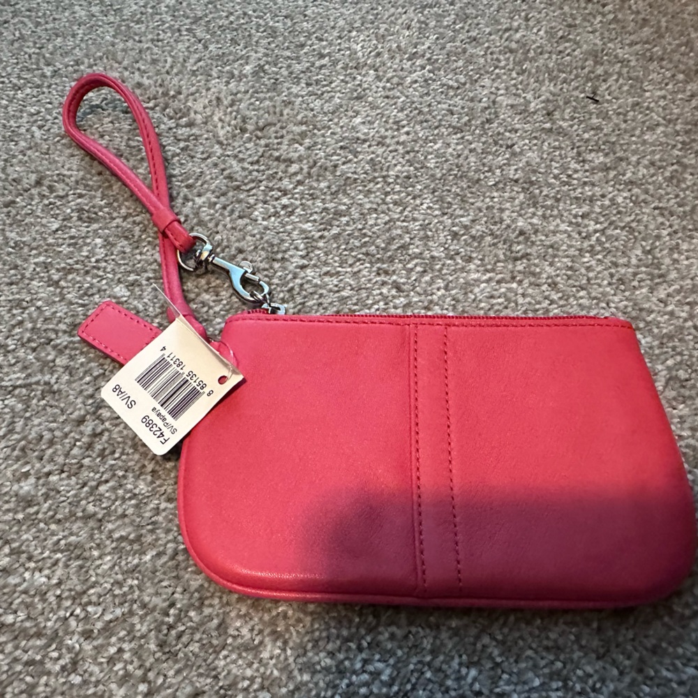 Coach Wristlet in Papaya leather with silver hardware